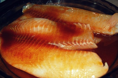 marinade tilapia in spices and olive oil